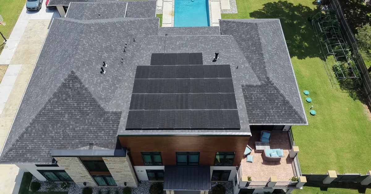 Aerial view of residential solar panels on a Tulsa home’s shingle roof