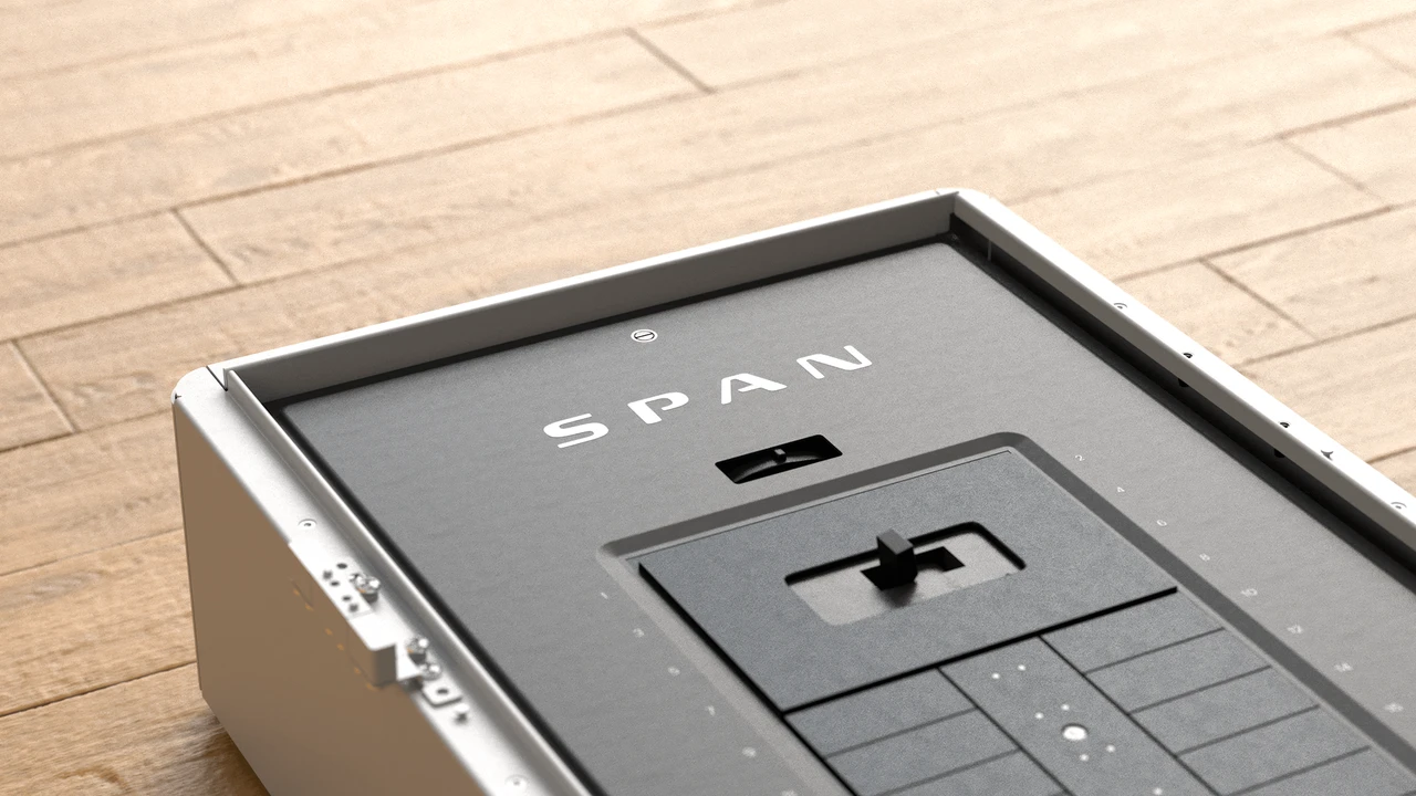 SPAN smart panel with door open showing circuit breakers and SPAN branding on hardwood floor